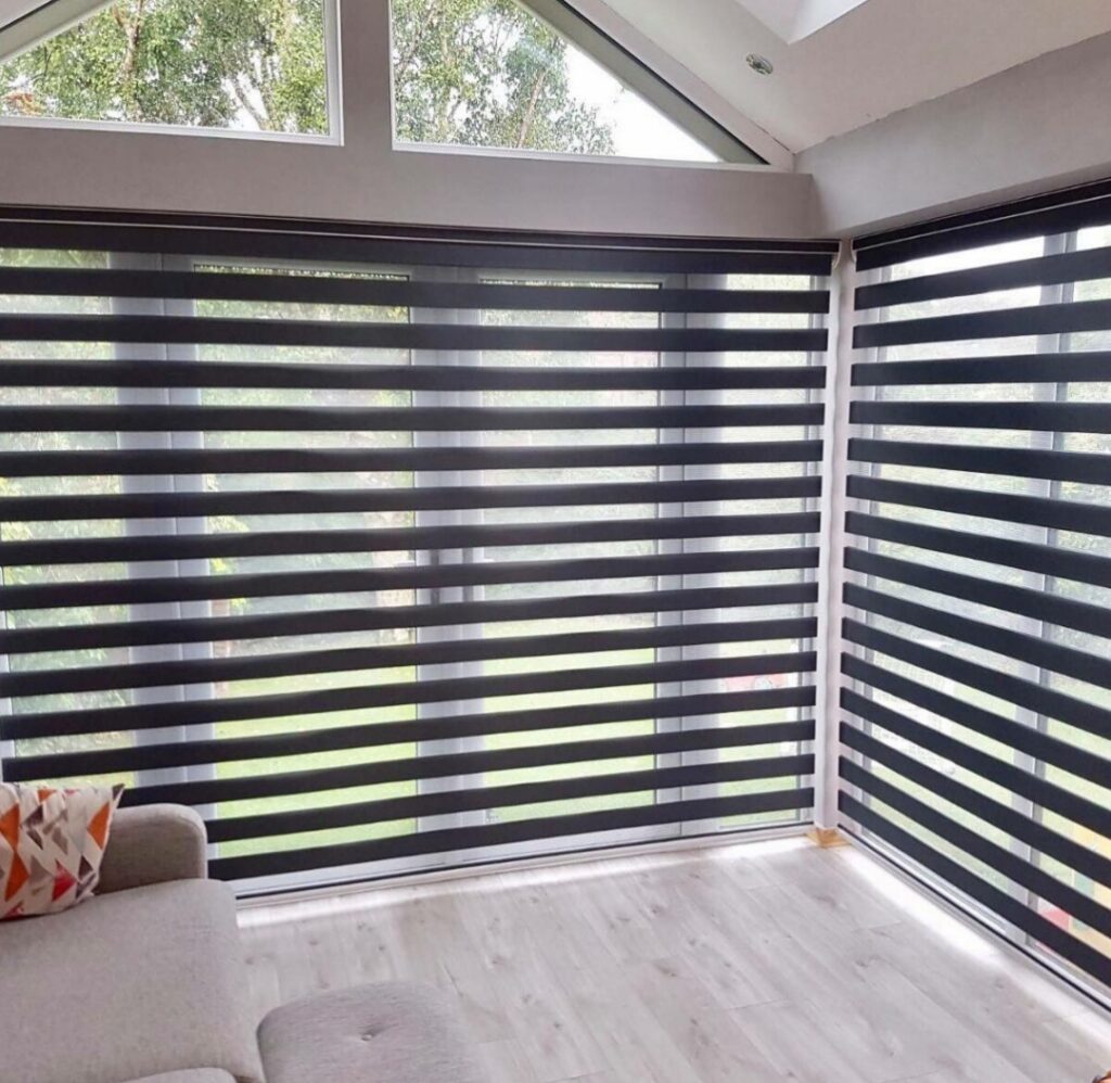 Zebra blind curtain installed on large living room windows for stylish light control and privacy.