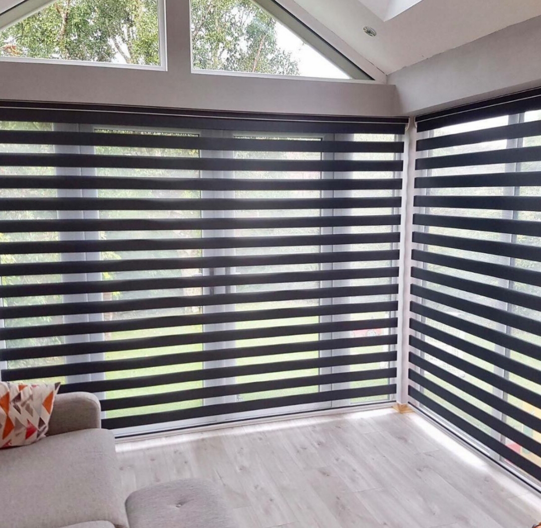 Zebra blind curtain installed on large living room windows for stylish light control and privacy.