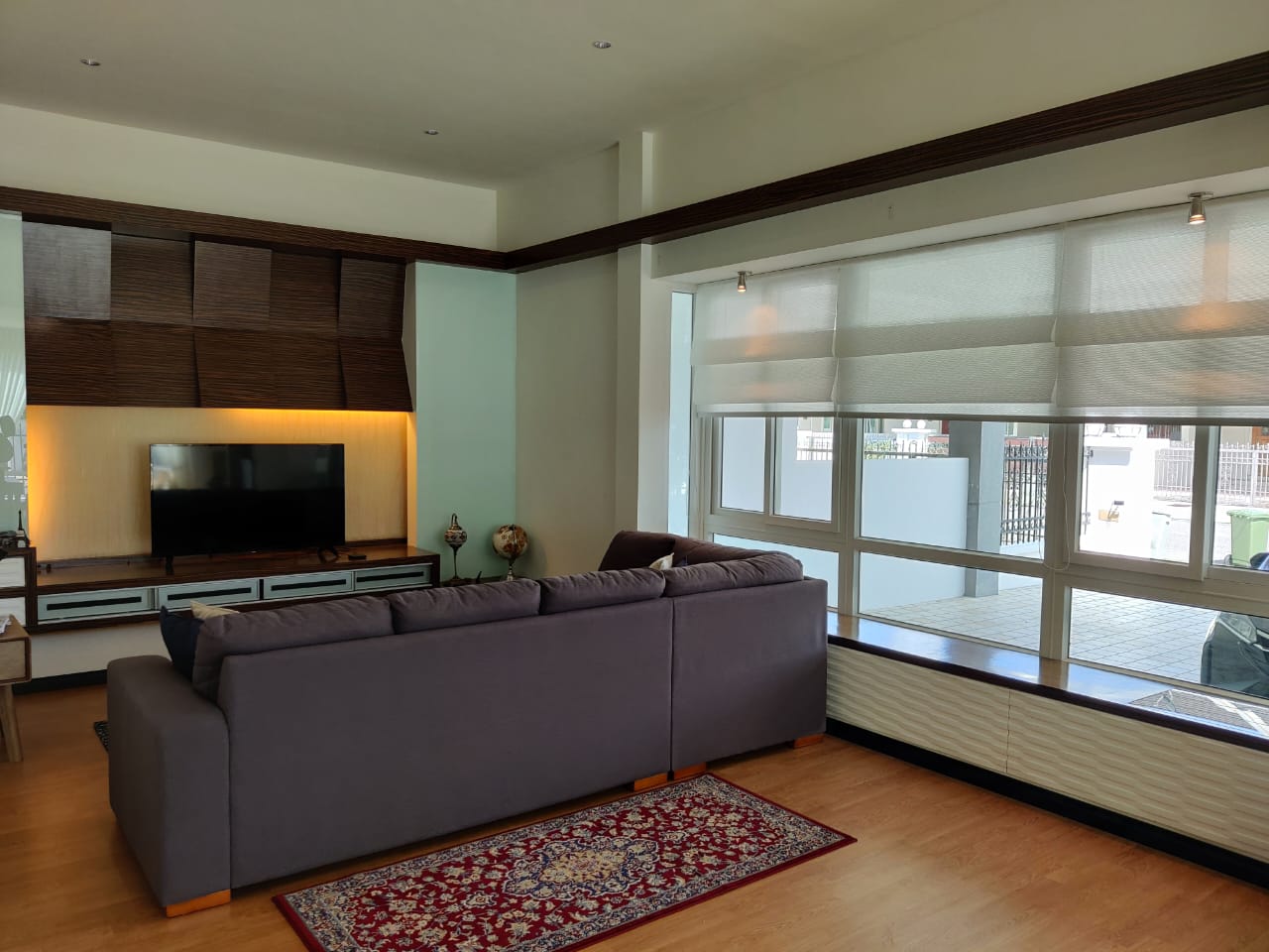 Roman blinds installed across large living room windows, adding soft privacy, filtered daylight, and a refined home interior finish.