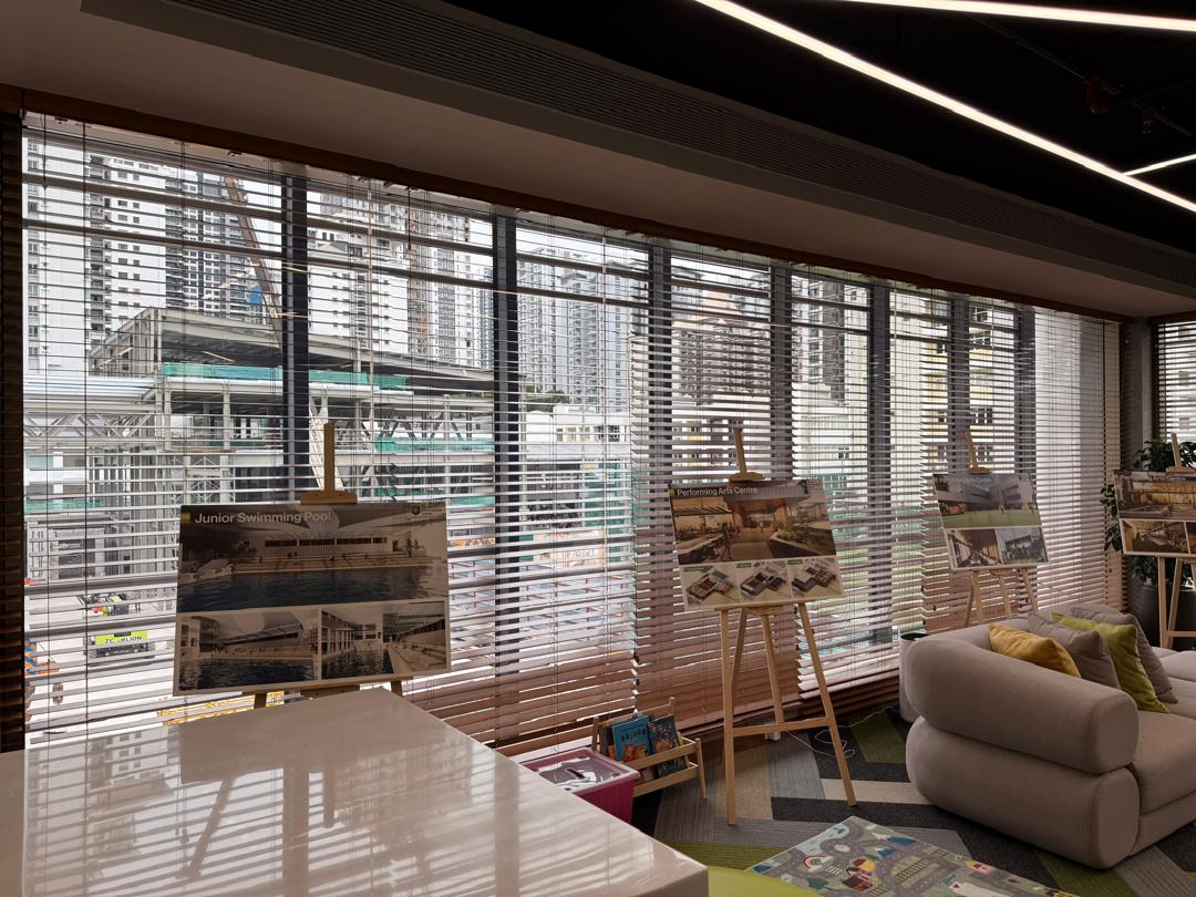 Wooden venetian blinds installed across large showroom windows, offering refined daylight control, privacy, and a polished interior finish.