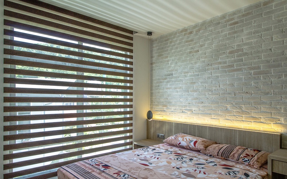 Zebra blind curtain installed in a modern bedroom for adjustable sunlight, privacy, and stylish window coverage.