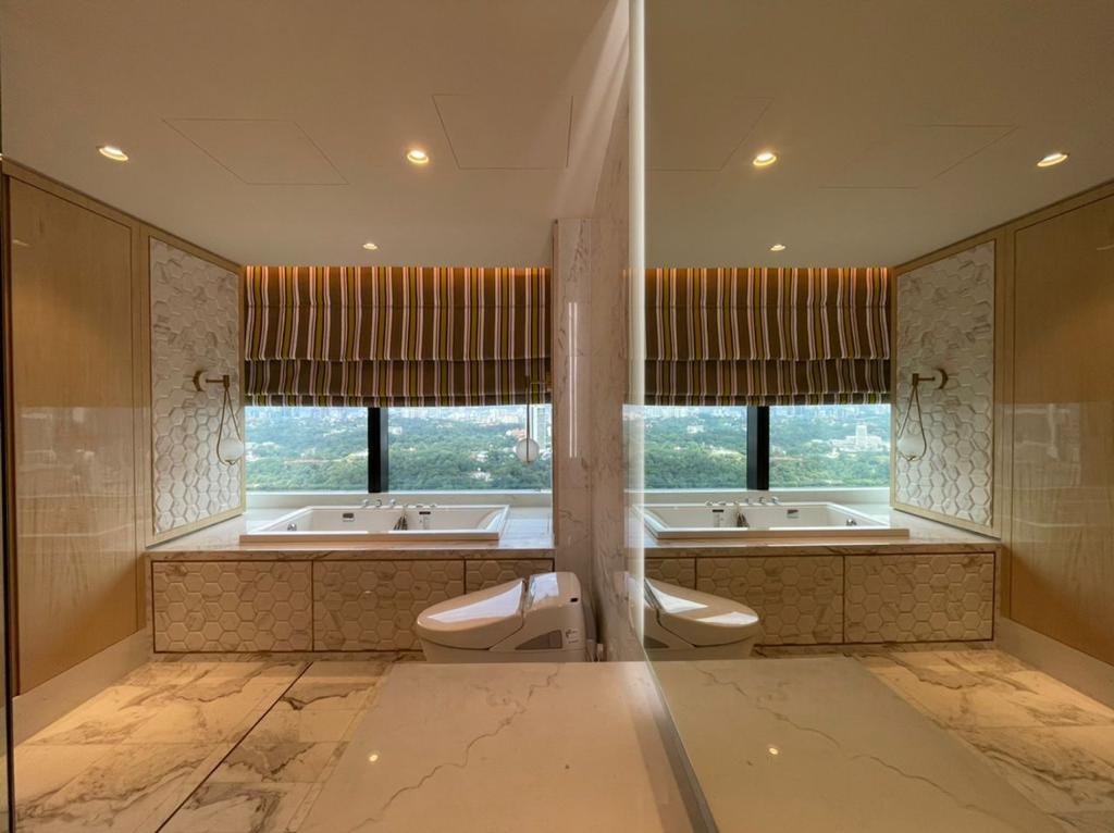 Roman blinds fitted above a luxury bathroom bathtub, adding soft privacy, warm texture, and an elegant decorative window finish.