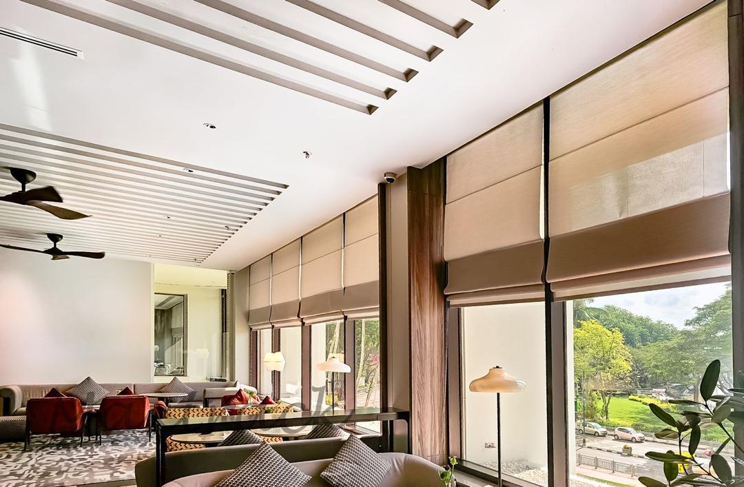 Roman blinds installed across tall lounge windows, adding soft daylight control, privacy, and a refined modern interior finish.